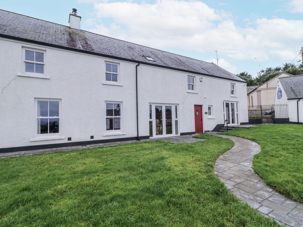 A house exterior with a pathway and grass at Foyle Cottage near Strabane