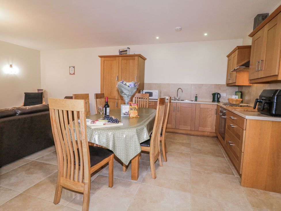 A kitchen with a table and chairs at Foyle Cottage near Strabane