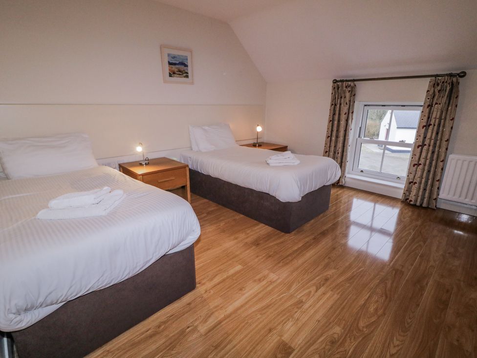 A bedroom with two single beds at Foyle Cottage near Strabane