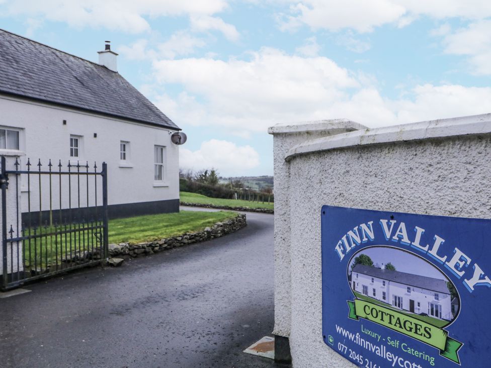 A cottage entrance with a gate and signage at Finn Valley near Strabane