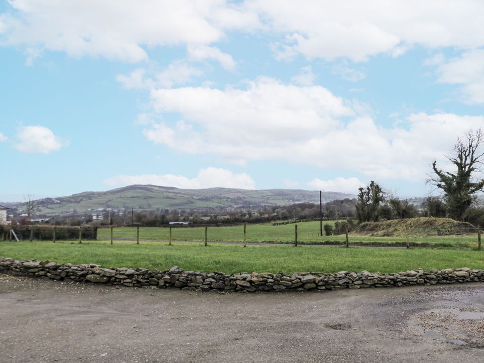 A landscape view with mountains and grass fields at Foyle Cottage near Strabane