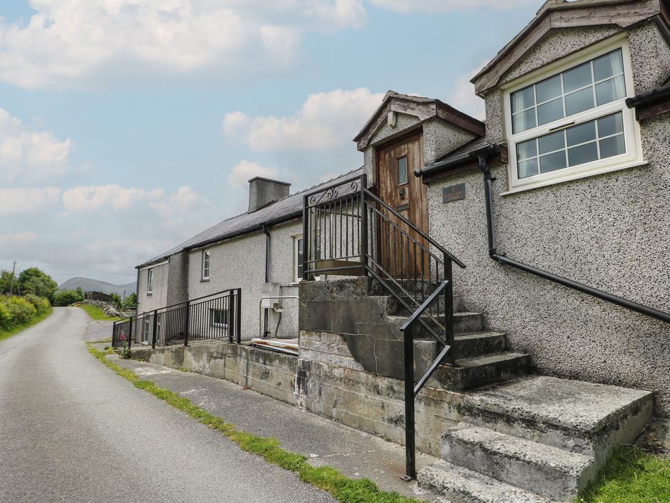 A house with a staircase and railing at Glan y Gors in Dinorwic near Llanberis