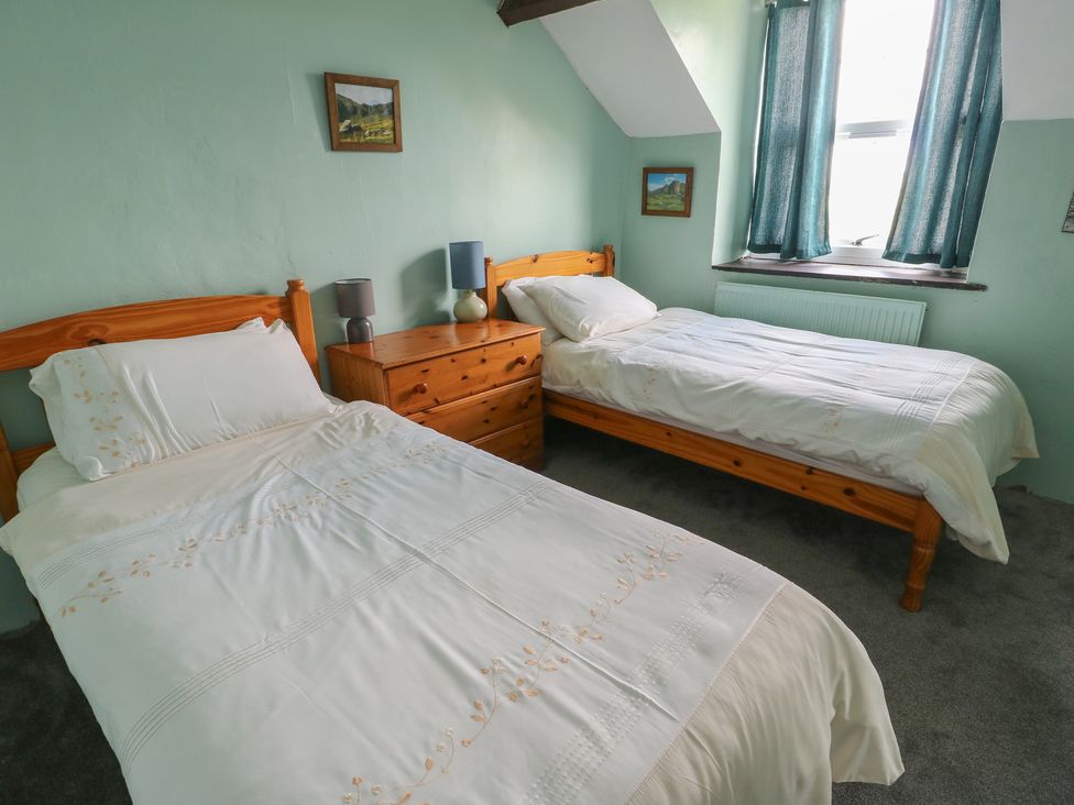 A bedroom with two beds and a window at Glan y Gors Dinorwic near Llanberis