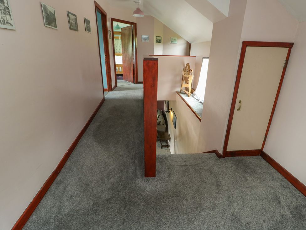 A hallway with doors and a railing at Glan y Gors in Dinorwic near Llanberis