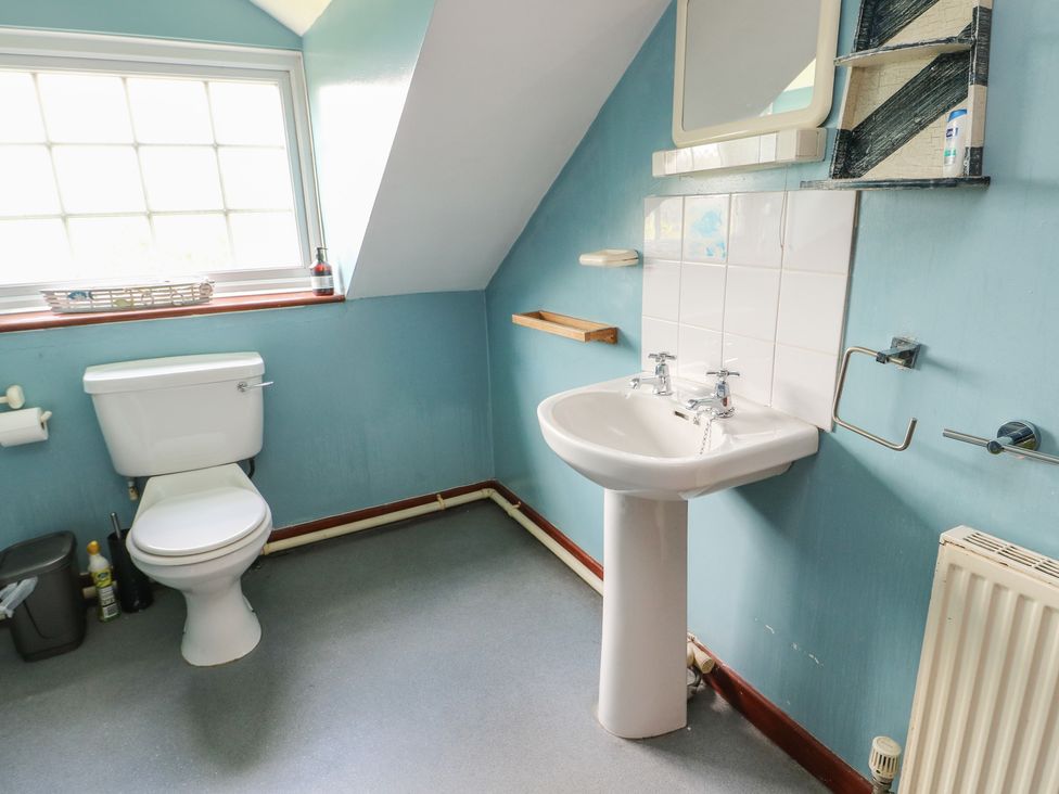 A bathroom with a toilet and sink at Glan y Gors in Dinorwic near Llanberis