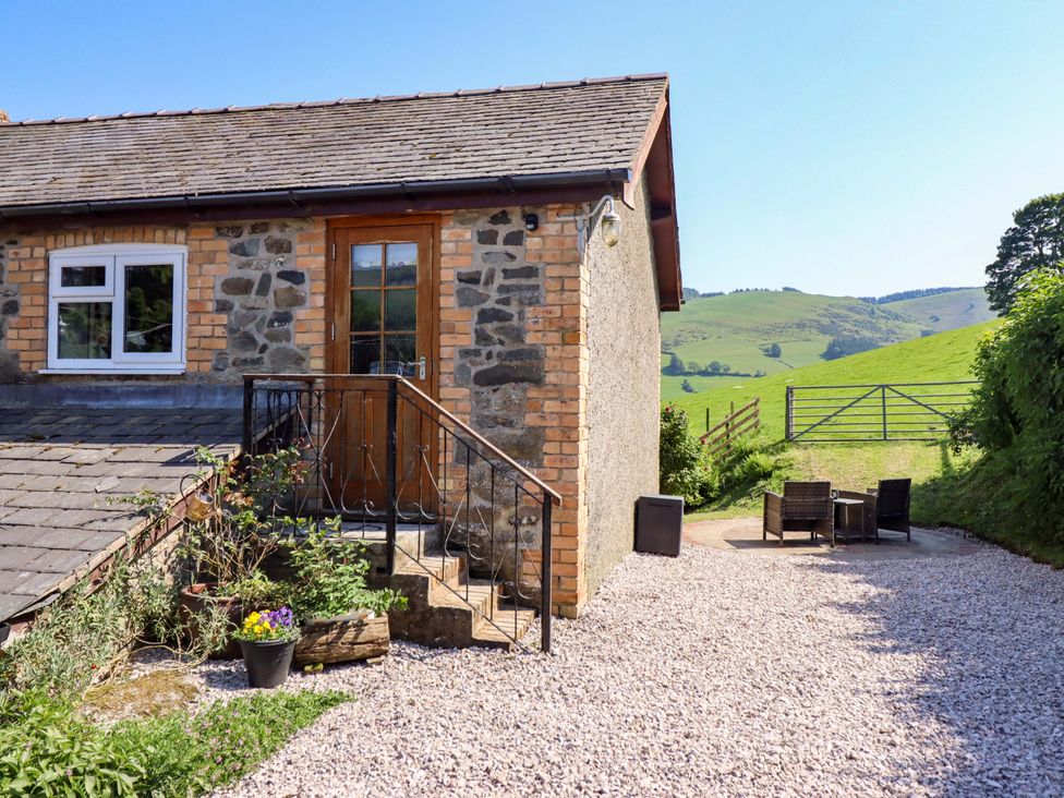 An outdoor area with steps leading to a door at Peniarth in Penybontfawr near Oswestry