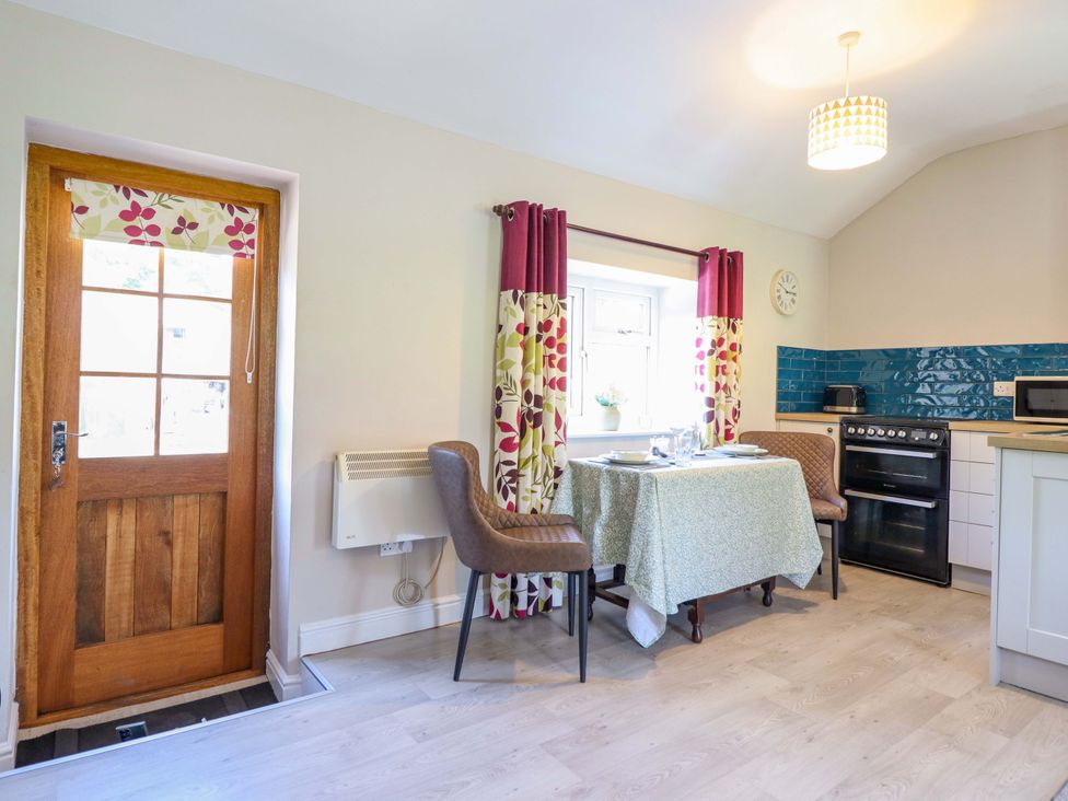 A kitchen with a table and chairs at Peniarth in Penybontfawr near Oswestry