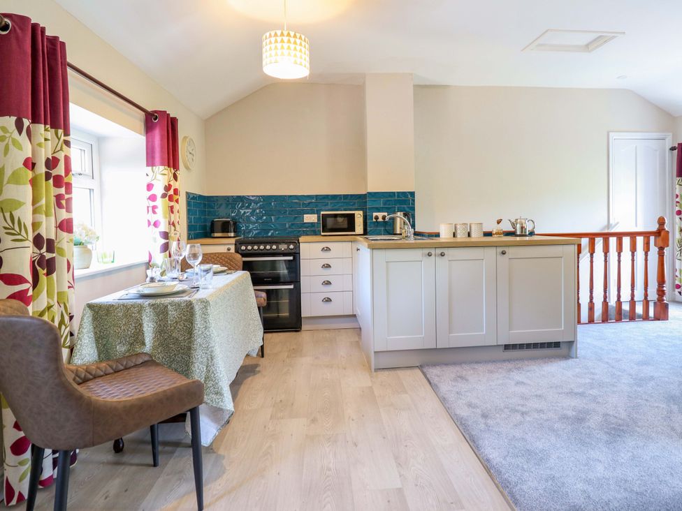 A kitchen with a dining table set at Peniarth in Penybontfawr near Oswestry