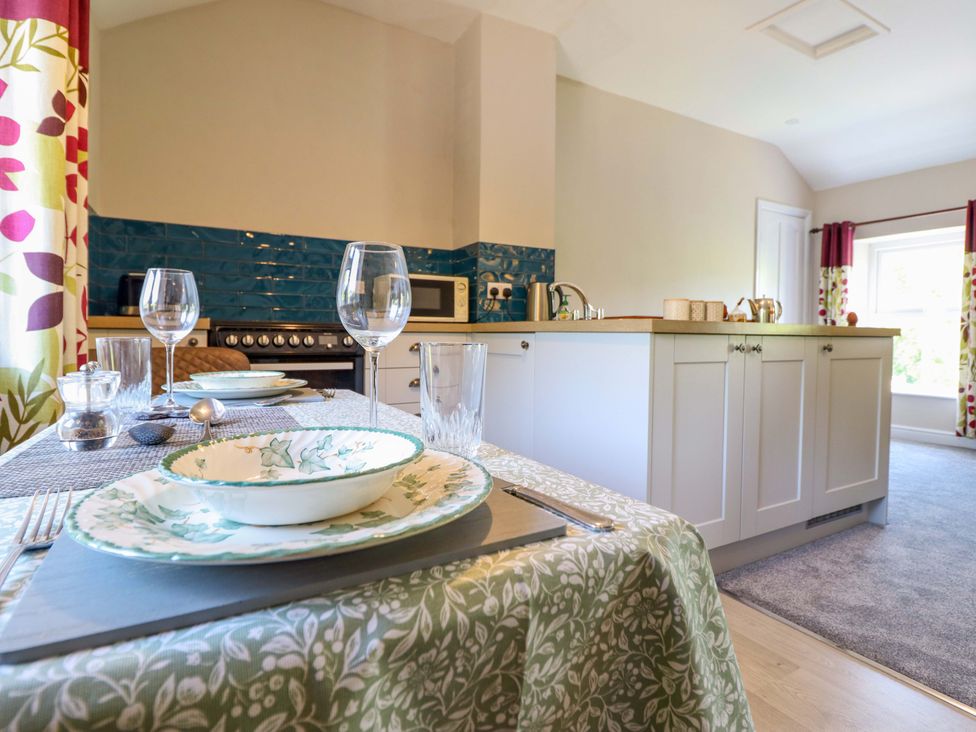 A kitchen with a table set for dining at Peniarth in Penybontfawr near Oswestry