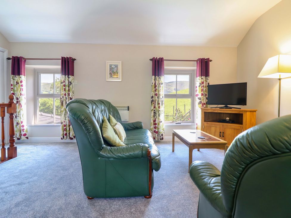 A living room with a sofa and television at Peniarth in Penybontfawr near Oswestry