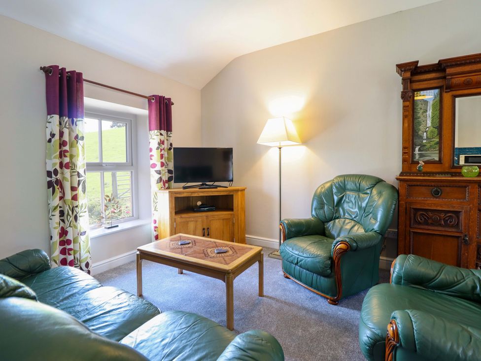 A living room with a sofa and coffee table at Peniarth in Penybontfawr near Oswestry