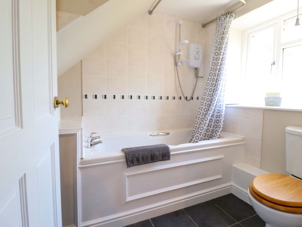 A bathroom with a bath tub and shower at Peniarth in Penybontfawr near Oswestry