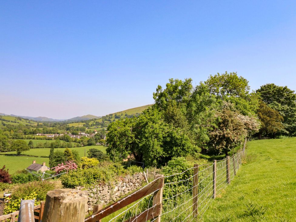 A view of trees and a village in a field at Peniarth in Penybontfawr near Oswestry