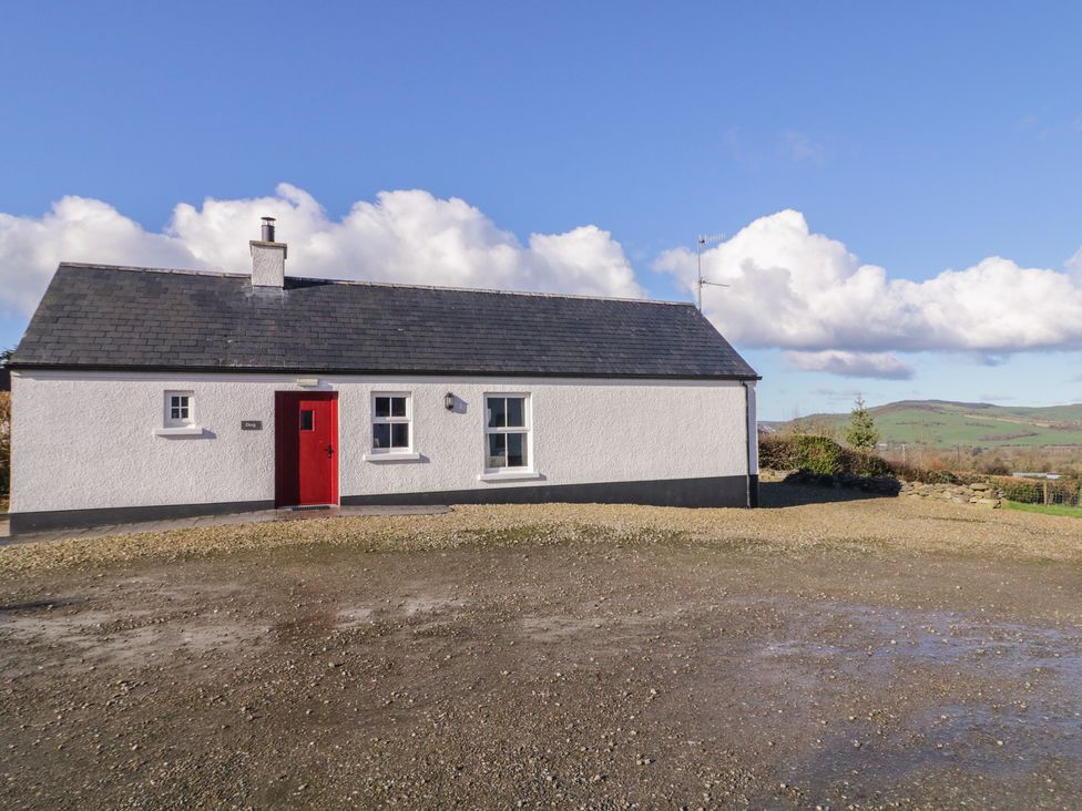 A house with a red door and windows at Derg Cottage 