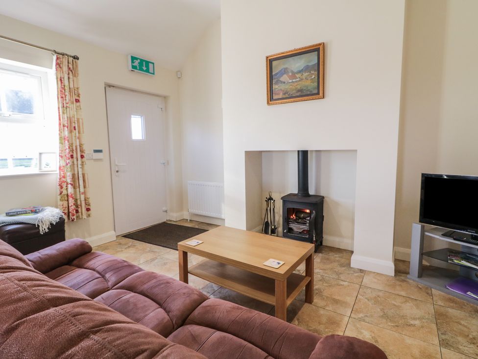 A living room with a coffee table and sofa at Derg Cottage