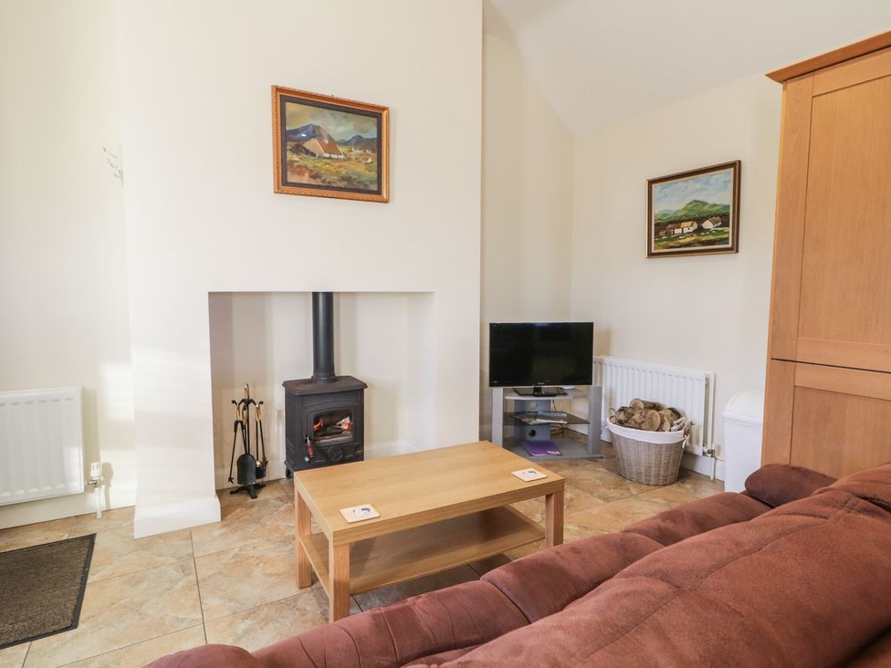 A living room with a sofa and fireplace at Derg Cottage
