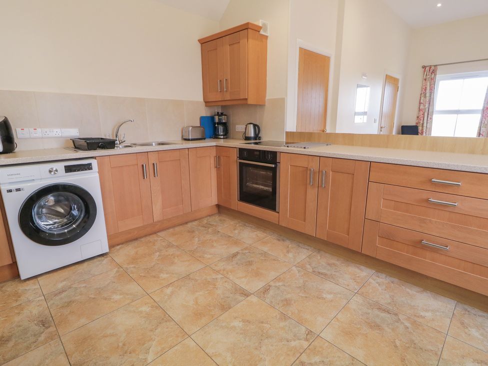 A kitchen with appliances and cabinets at Derg Cottage