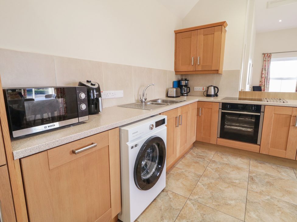 A kitchen with appliances and cabinets at Derg Cottage 