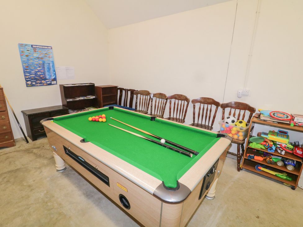 A game room with a pool table and chairs at Derg Cottage