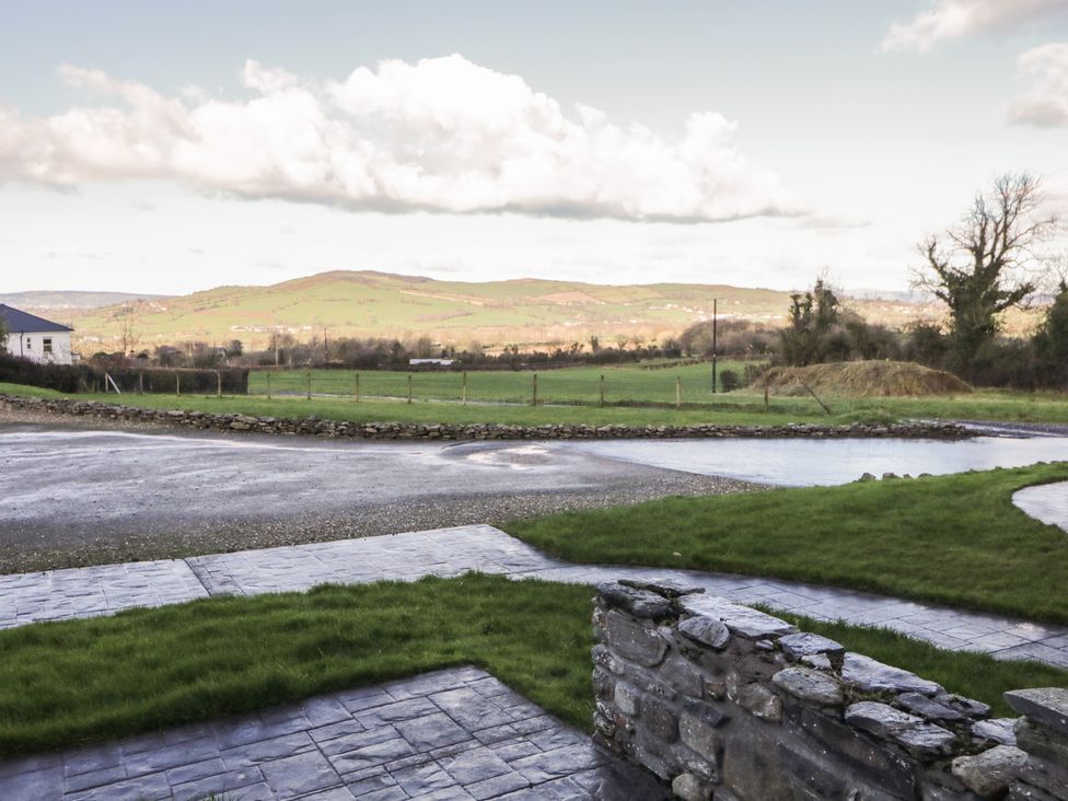 An outdoor view with mountains and fields at Finn Cottage