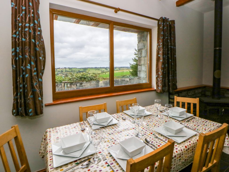 A dining room with a table set for meals at Y Bwthyn in Swyddffynnon near Pontrhydfendigaid