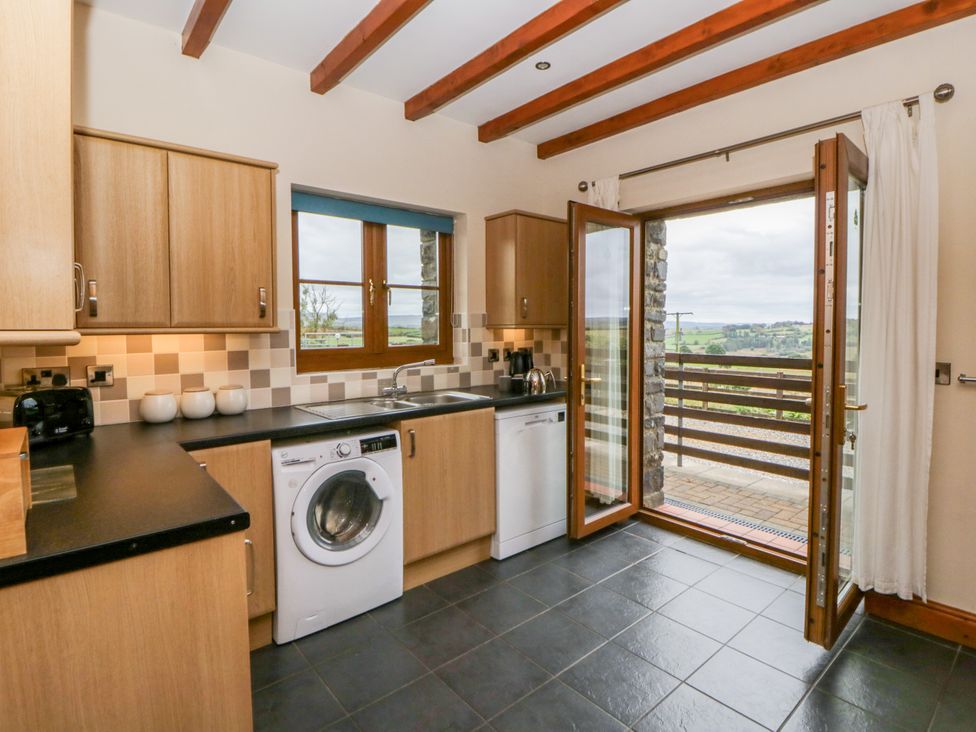 A kitchen featuring appliances and a view at Y Bwthyn in Swyddffynnon near Pontrhydfendigaid
