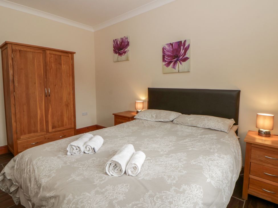A bedroom with a bed and wardrobe at Y Bwthyn near Pontrhydfendigaid