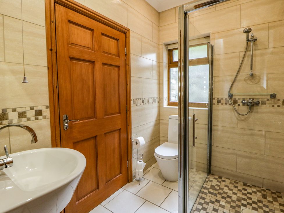 A bathroom with a sink, toilet, and shower at Y Bwthyn in Swyddffynnon near Pontrhydfendigaid