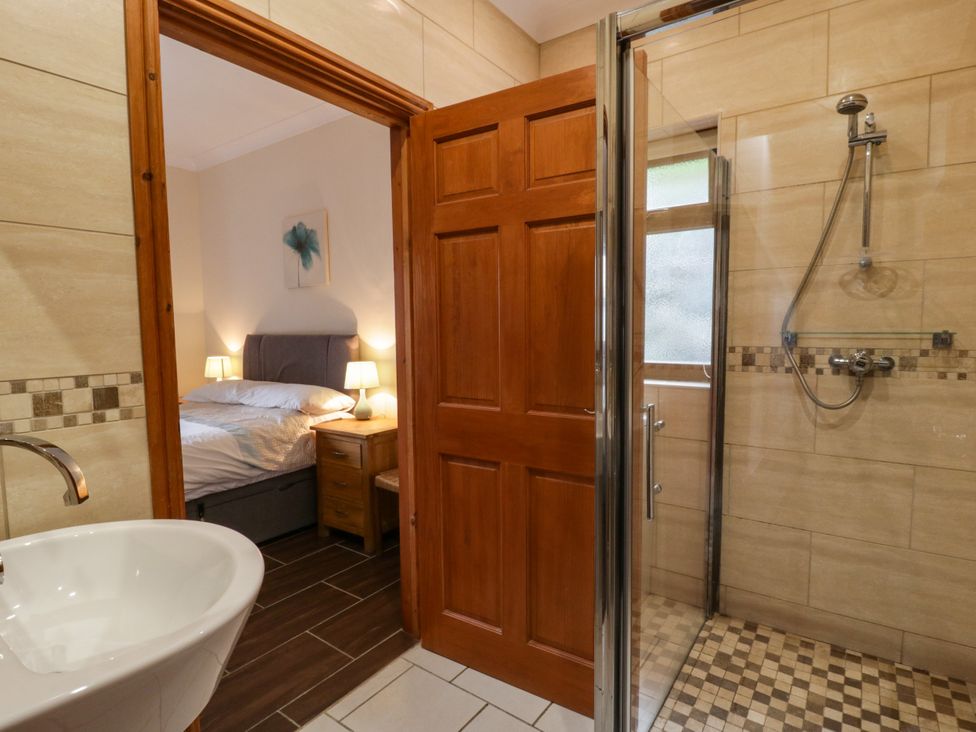 A bathroom with a shower and sink at Y Bwthyn in Swyddffynnon near Pontrhydfendigaid