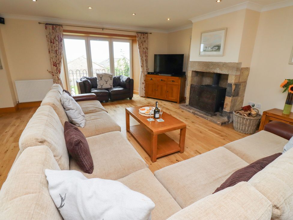 A living room with a sofa and coffee table at Granary Stone House in Embleton