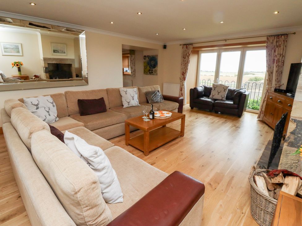 A living room with a sofa and coffee table at Granary Stone House in Embleton