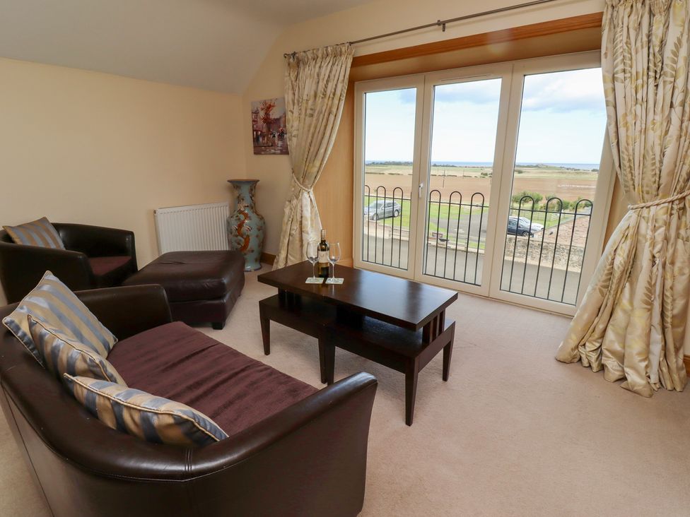 A living room with a sofa and coffee table at Granary Stone House in Embleton