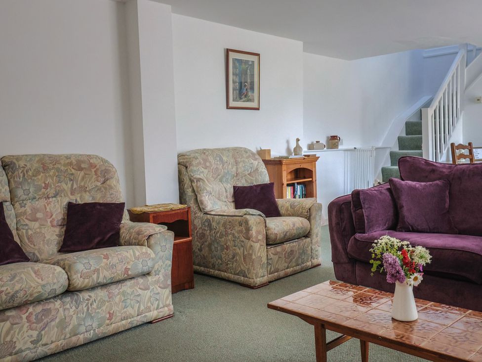 A living room with armchairs and a coffee table at West Bowden Farm Knowstone near South Molton