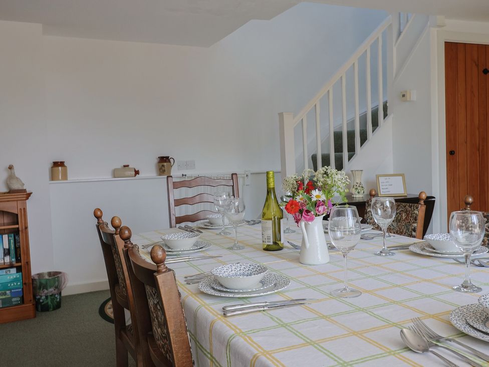 A dining room with a table set for dinner at West Bowden Farm Knowstone near South Molton