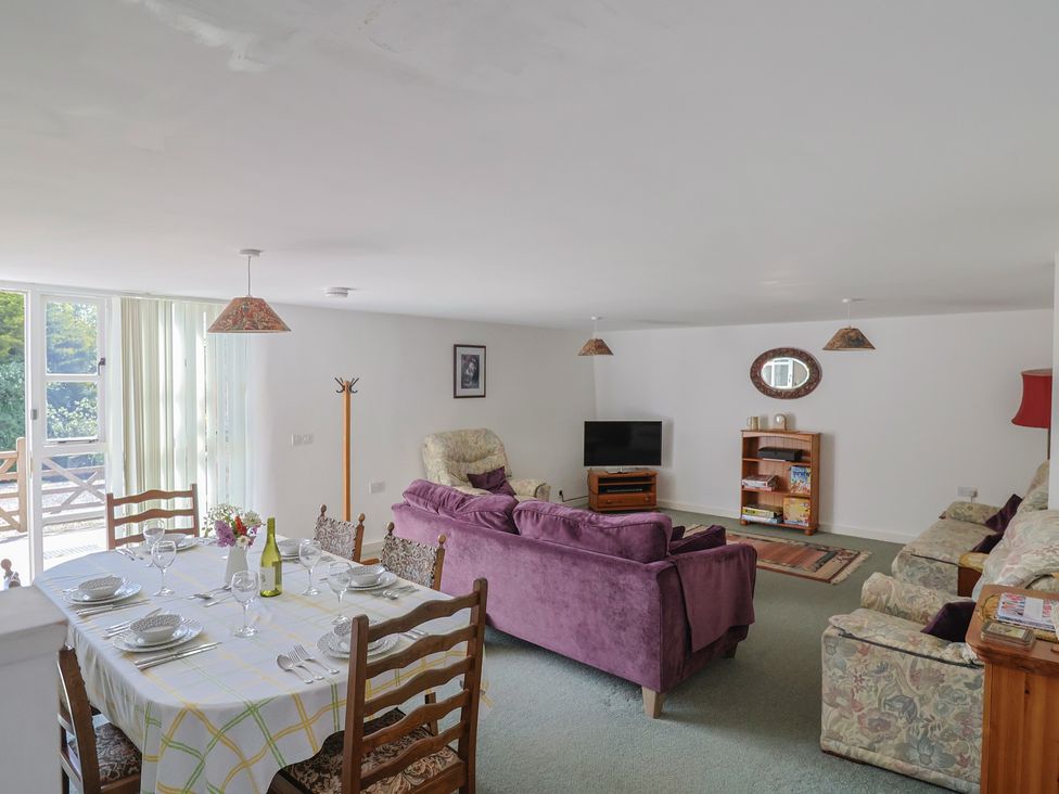 A living room with a dining table and chairs at West Bowden Farm Knowstone near South Molton