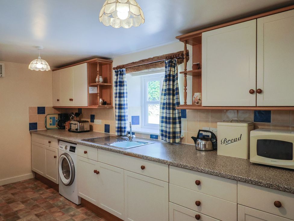 A kitchen with countertop and appliances at West Bowden Farm in Knowstone near South Molton