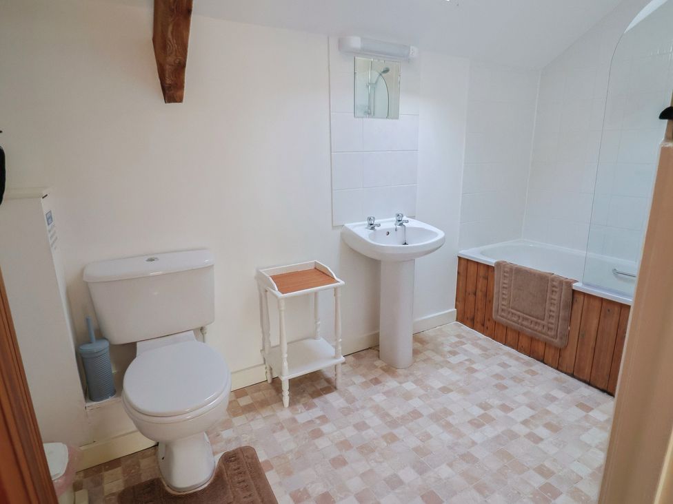 A bathroom with a toilet, sink, and bathtub at West Bowden Farm in Knowstone near South Molton