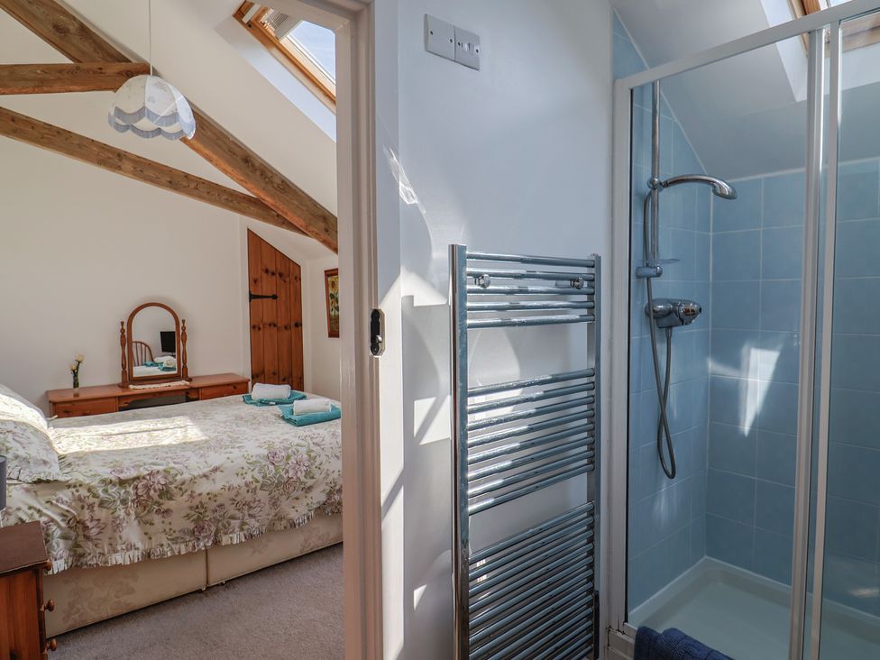 A bedroom with a shower enclosure at West Bowden Farm in Knowstone near South Molton