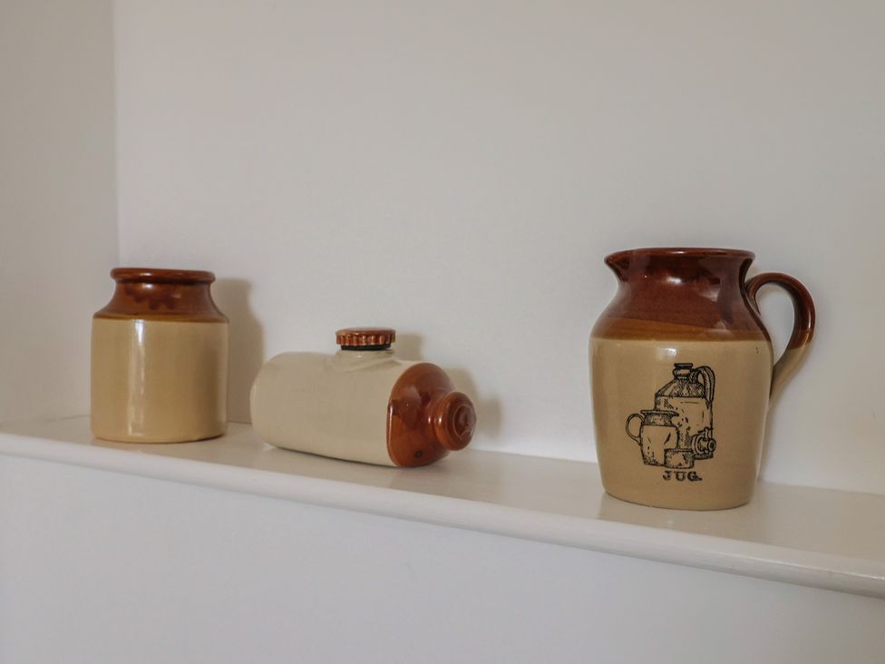 A shelf with three ceramic containers at West Bowden Farm Knowstone near South Molton