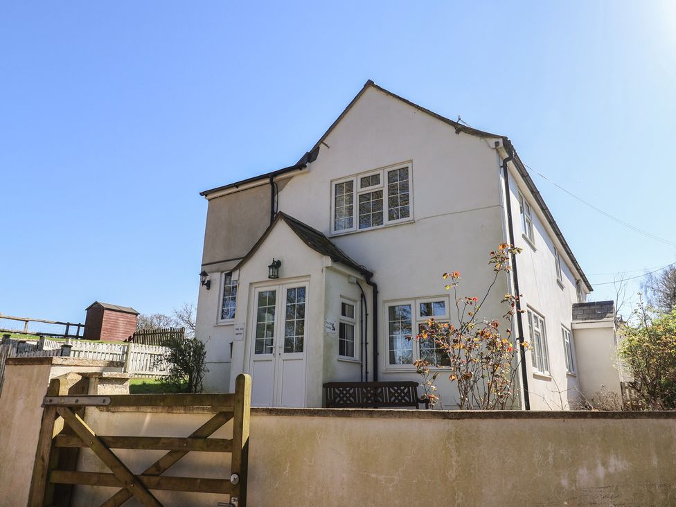 An exterior view of a house with a garden at The Old Smithy in Dottery near Bridport