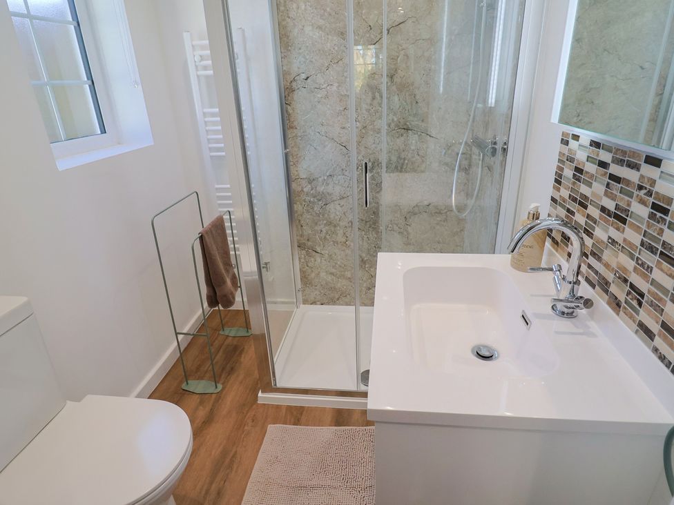 A bathroom with a shower and sink at The Old Smithy in Dottery near Bridport