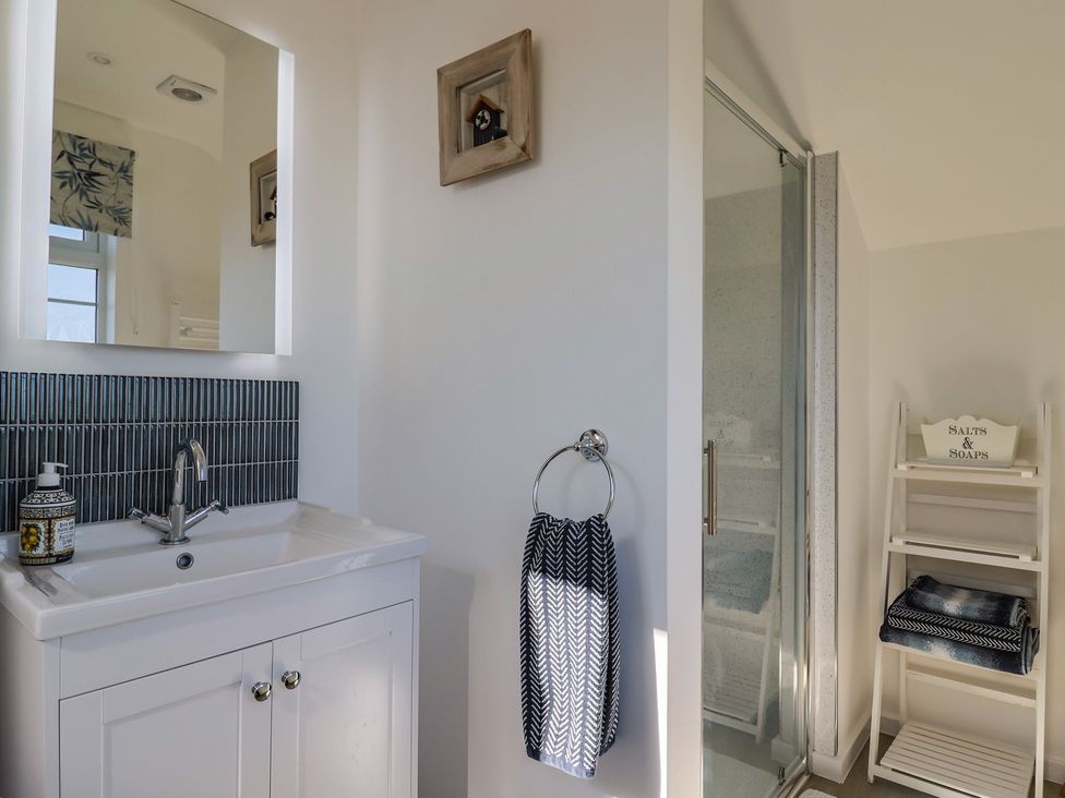 A bathroom with a sink and shower at The Old Smithy Dottery near Bridport