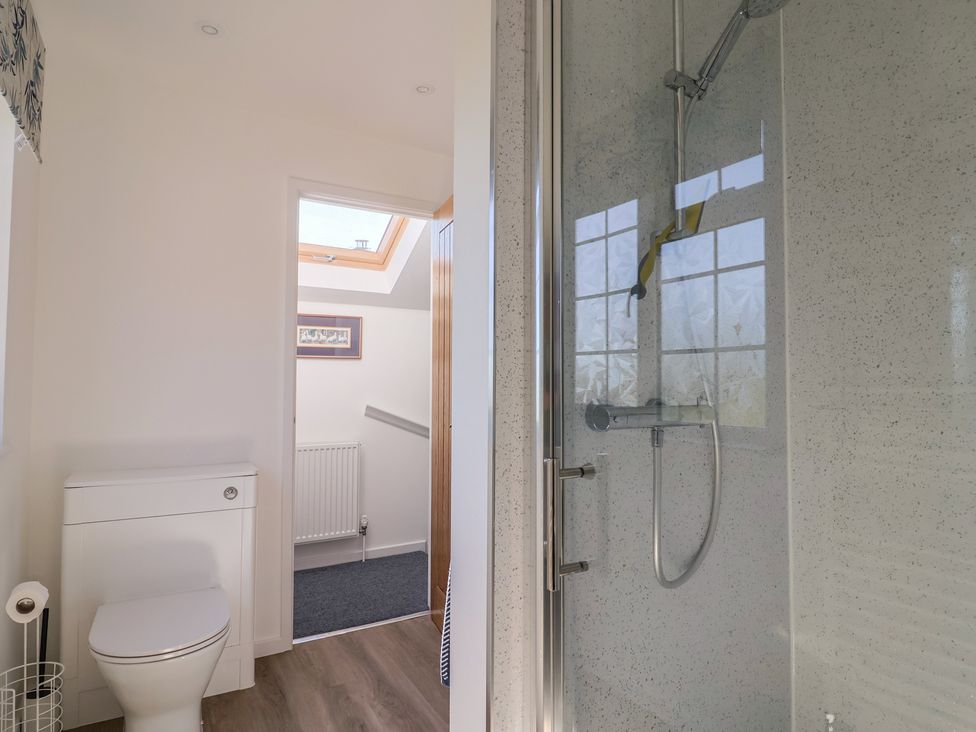 A bathroom with a shower and toilet at The Old Smithy Dottery near Bridport