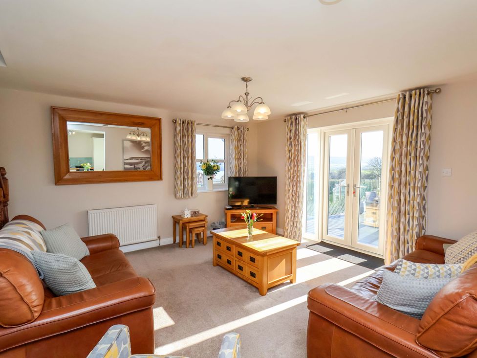 A living room with a television and seating at Heather Croft in Robin Hood's Bay