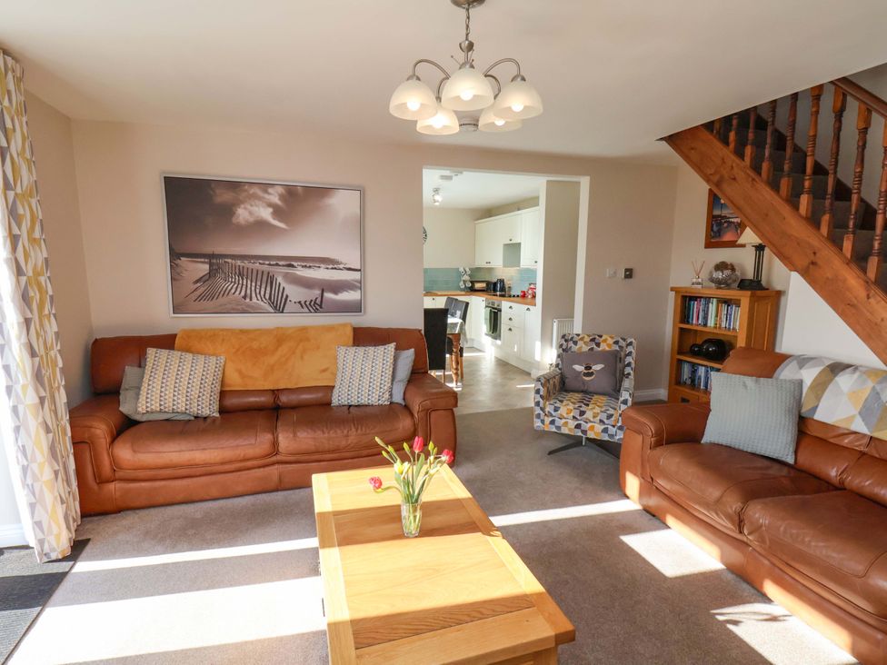 A living room with a coffee table and brown sofas at Heather Croft Robin Hood's Bay