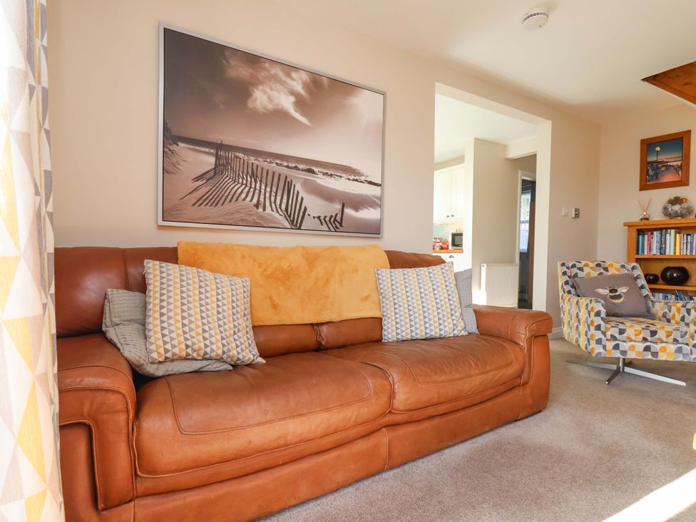 A living room with a sofa and chair at Heather Croft in Robin Hood's Bay