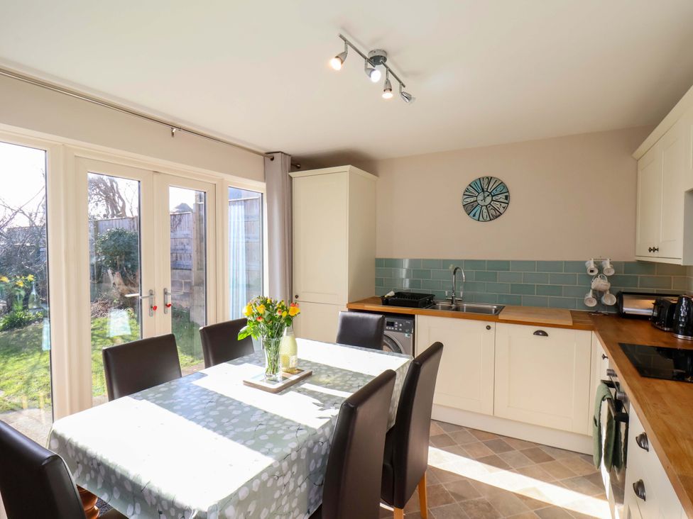 A kitchen with a table and chairs at Heather Croft in Robin Hood's Bay