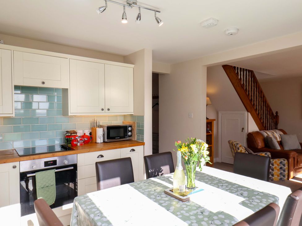 A kitchen with a table and chairs at Heather Croft in Robin Hood's Bay