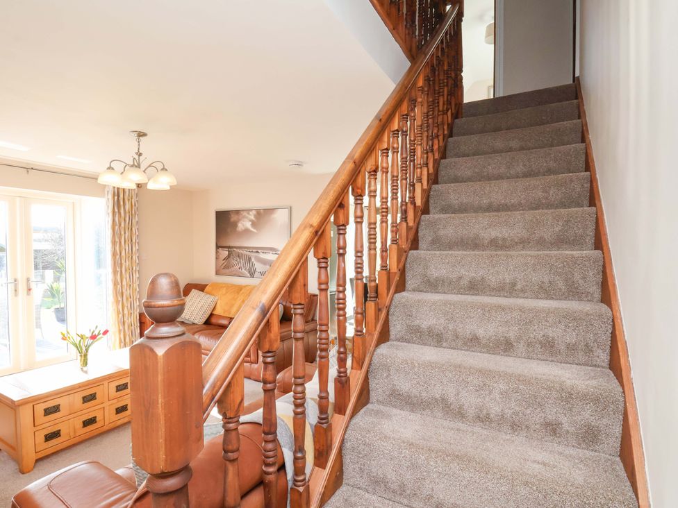 A living room with a staircase and coffee table at Heather Croft in Robin Hood's Bay