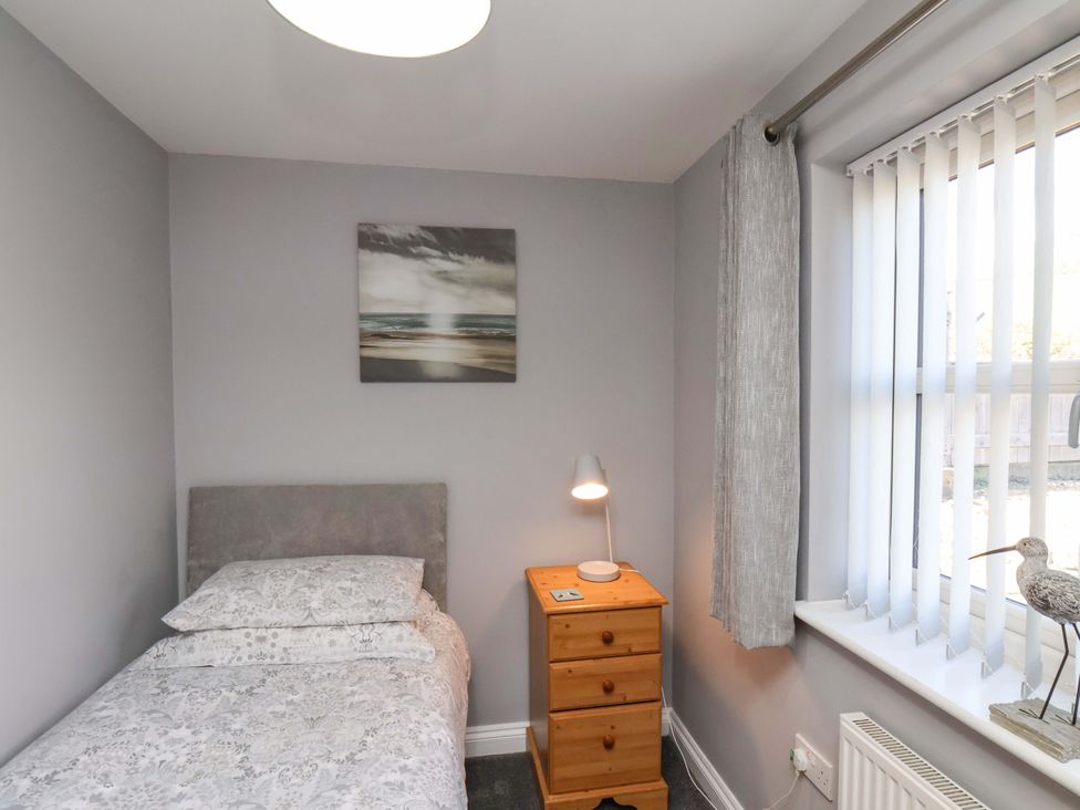 A bedroom with a bed and bedside table at Heather Croft in Robin Hood's Bay